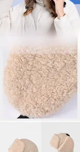 Detail of beige winter hat showing quilted windproof fabric and thick fleece lining