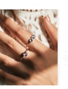Macro shot of S925 sterling silver rings with purple zircon stones on lace fabric