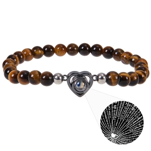 Detail of tiger eye beaded bracelet showing the 100 languages I Love You projection charm