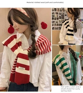 Close-up of stylish knitted striped shawls in red, black, and green for layered outfits
