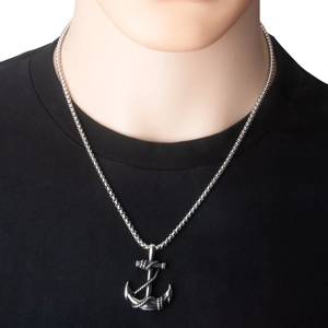 Detailed macro view of retro silver stainless steel ship anchor pendant with rope details