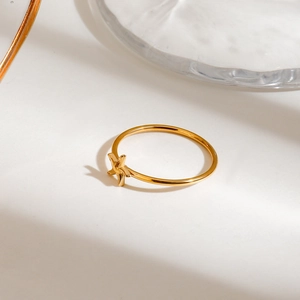 Detail of a golden starfish ring in stainless steel with a minimalist ocean design