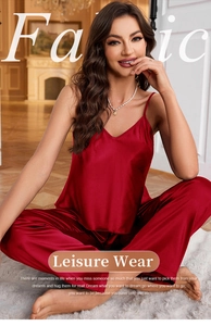 Detail of burgundy satin sleepwear set showing silk-like texture and elegant V-neck design