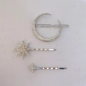 Detail view of silver star and moon hair clips set featuring sparkling rhinestones