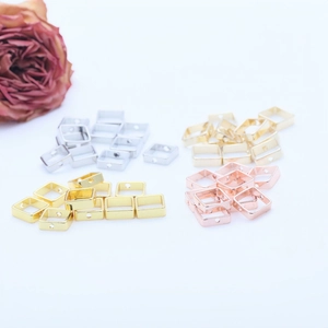Macro view of 14K gold filled square bead frames with side holes for DIY jewelry