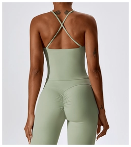 Detail of cross-back yoga vest and scrunch leggings in breathable Morandi green fabric