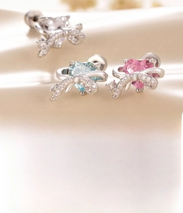 Macro detail of heart bow tragus piercing with zircon and 0.8x6mm bar size