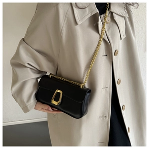 Detail showing the black PU leather square bag with gold chain strap and U-shaped buckle
