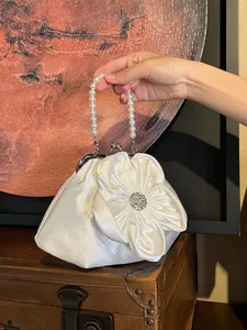 Elegant white satin handbag with pearl handle and large floral crystal decoration