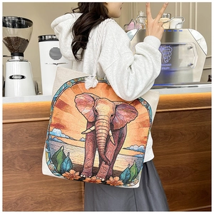 Detailed shot of an elephant embroidered canvas tote bag with cotton rope handles