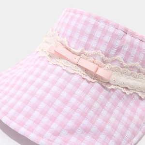 Close-up of pink checkered sun hat brim with delicate white lace and a sweet bow detail