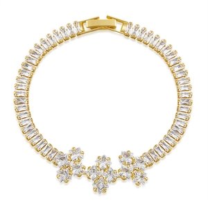 Detail of luxury gold bracelet featuring square-cut zircons and elegant flower clusters