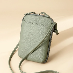 Minimalist sage green pebbled leather mini crossbody phone bag with double zippers