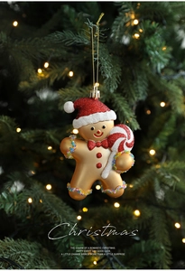 Detail of gingerbread man Christmas ornament with glitter and beads on a tree