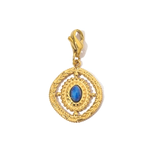 Detail view of retro gold pendant with blue oval stone and functional lobster clasp