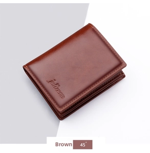 Close-up of brown oiled leather wallet texture with precision stitching and brand logo