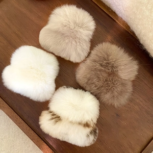 Pinces à cheveux en peluche blanc et marron sur fond de bois chaud pour l'hiver