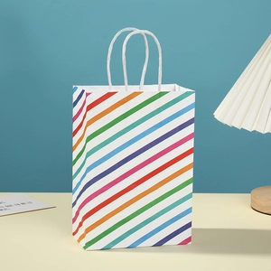 Colorful striped paper gift bag with rainbow patterns and durable white paper handles