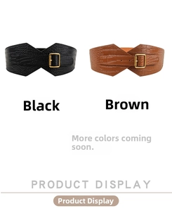 Detail of wide crocodile embossed leather belts in black and brown with gold pin buckles