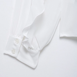 Elegant white chiffon long sleeve blouse featuring ruffled cuffs and button detail