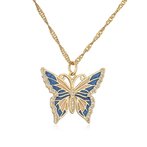 Macro view of 18K gold-plated butterfly pendant with blue enamel and sparkling zircons