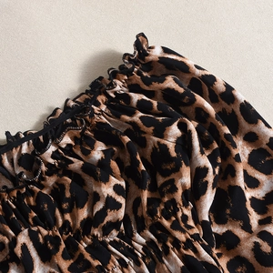 Detailed view of elastic leopard print neckline with fine stitching on fabric