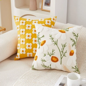 Close-up of luxury chenille pillow with 3D embroidery and floral daisy texture