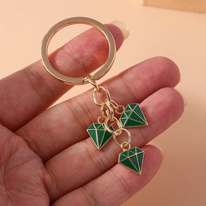 Fashionable gold-tone keychain with triple green diamond-shaped drip oil pendants
