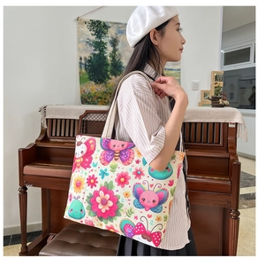 Detail of high-capacity canvas tote bag with colorful cartoon butterfly floral patterns