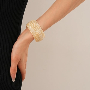 Macro detail of minimalist cream marbled acetate open cuff bracelet for women