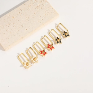 Three pairs of elegant gold star drop earrings in white, red, and black enamel finish