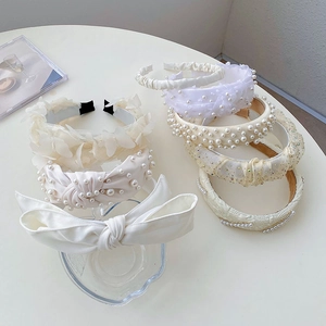 Detailed collection of white pearl and lace headbands with various elegant bow designs