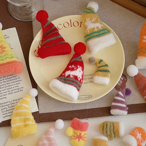 Close-up of colorful mini knitted Christmas hats and gloves for DIY festive decorations