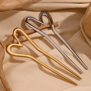 Polished 18K gold and silver stainless steel heart hair sticks on beige silk
