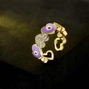 Gold open ring with heart patterns featuring purple evil eye enamel and cubic zirconia