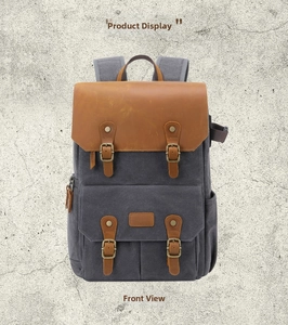 Front view of a waterproof canvas camera backpack with vintage leather straps
