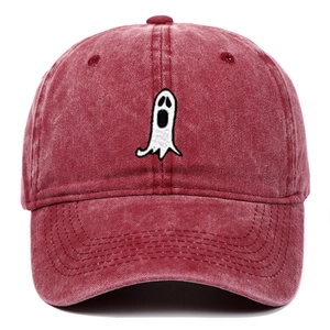 Close-up of white ghost embroidery on a vintage washed red cotton baseball cap