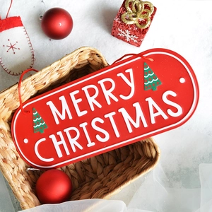 Red Merry Christmas oval metal hanging sign with white relief letters and green tree decor