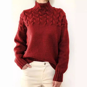 Chic red turtleneck sweater featuring chunky cable knit texture and long sleeves for women