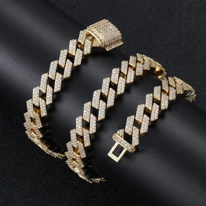 Detailed macro view of 18K gold Cuban link chain featuring double-row zircon pavé settings