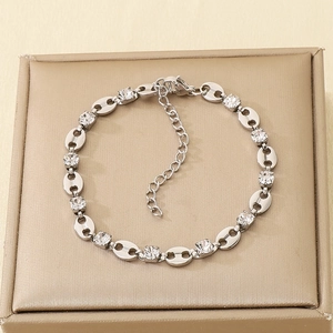 Detail of silver pig-nose chain bracelet with prong-set zircons and adjustable clasp