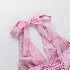 Close-up of pink jacquard satin halter neck ties and back lace-up detail on the dress
