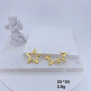 Gold hollow star-shaped earrings on stone pedestal with angel sculpture decor, 30x30mm
