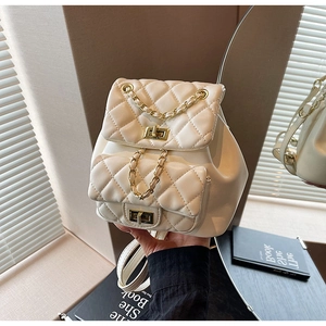 Detail view of quilted mini backpack showing double layers and golden chain strap