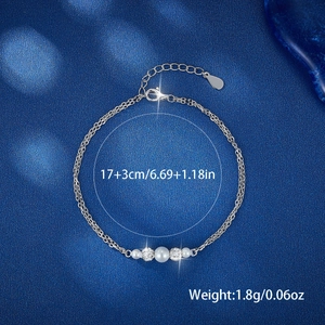 Macro detail of silver double-layer bracelet with pearls and weights showing 17+3cm length