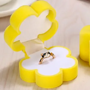 Floral yellow velvet jewelry box featuring a unique rose gold cat-shaped ring with blue eyes