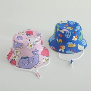 Close-up of kids' cotton bucket hats with adjustable chin straps and colorful cartoon prints
