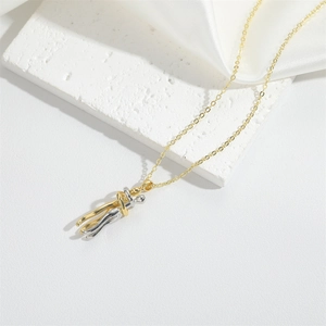 Minimalist gold and silver two-tone embrace pendant necklace on white stone with silk
