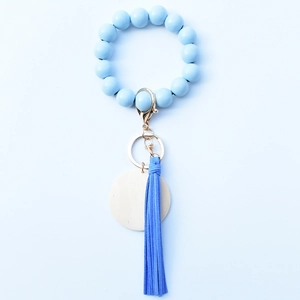 Light blue beaded wristlet keychain with wooden beads, leather tassel and golden alloy clasp