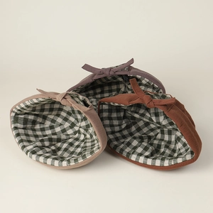 Three cotton brimless caps in violet, pink and rust red with checkered lining and bow decoration